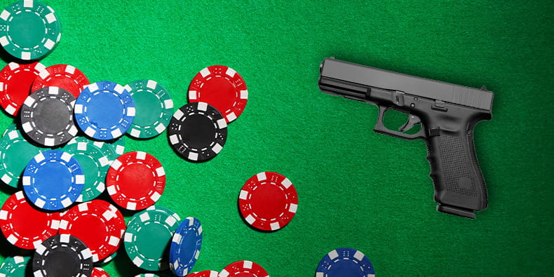 Pistol Placed On Top of a Table With Casino Chips