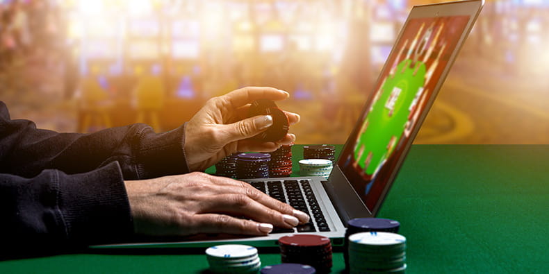  Online Casino Player with a Laptop over a Casino Table