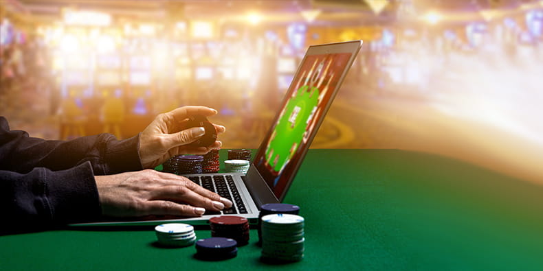 Online Poker Player on a Laptop with Casino Chips on Both Sides
