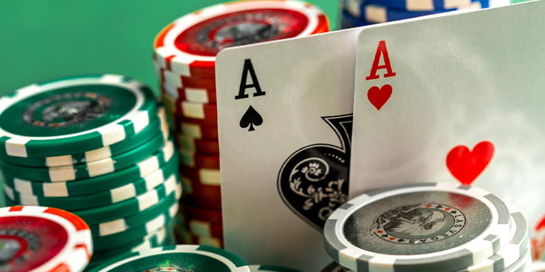 Two Aces Placed Between Poker Chips
